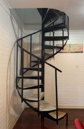Industrial helical staircase winding around a central newel Industrial spiral staircase.png