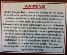 Sign disclaiming legal responsibility at a Kansas agritourism business Kansas agrotourism disclaimer.png