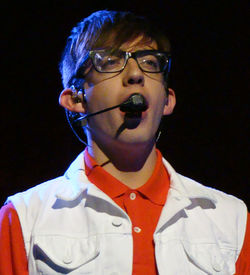 Kevin McHale Artie Abramsina esittämässä kappaletta "Don't Stop Believin" Kesäkuussa 2011, Glee Live! In Concert! aikana.