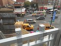 On Main Street below, some LIRR maintenance trucks are parked by the station.