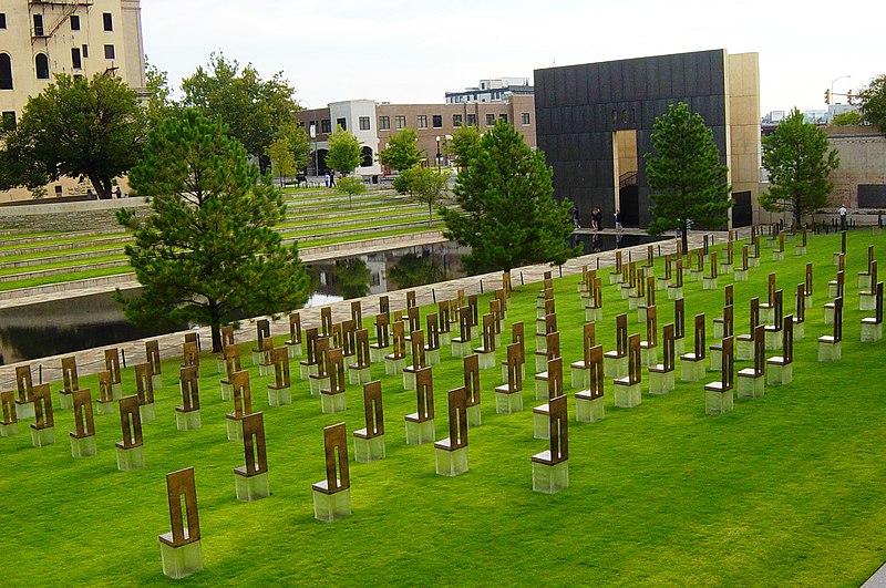 File:Oklahoma City National Memorial viewed from the south showing the memorial chairs, Gate of Time, Reflecting Pool, and Survivor Tree.jpg
