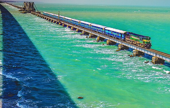 Pamban Bridge is a railway bridge which connects the town of Rameswaram on Pamban Island to mainland India. Opened on 24 February 1914, it was India's first sea bridge, and was the longest sea bridge in India until the opening of the Bandra-Worli Sea Link in 2010. The rail bridge is, for the most part, a conventional bridge resting on concrete piers, but has a double-leaf bascule section midway, which can be raised to let ships and barges pass through.