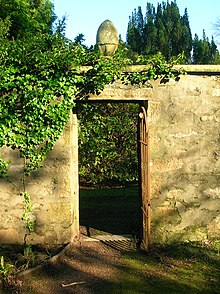 A stone pineapple in the gardens at Perceton House Perceton wall garden door and pineapple.JPG