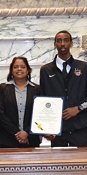 Principal Cindy Harcum and basketball team captain Bond at ceremony recognizing state championship in the House of Delegates in Annapolis, 2014 Principal Cindy Harcum and student.jpg