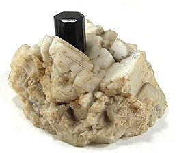 Schorl crystal on a cluster of euhedral feldspar crystals