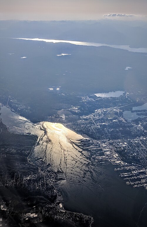West-looking afternoon aerial view of Sinclair Inlet, with Bremerton on the north (right) side, Port Orchard on the south (left) side; Hood Canal in t