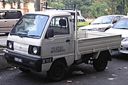 The pickup variant of the fifth generation Suzuki Carry is an example of a cab-forward pickup kei truck.