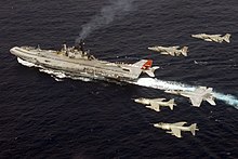 A pair of Indian Air Force Jaguars flying in formation besides a pair of Indian Navy Sea Harriers and a pair of U.S. Navy F/A-18 Super Hornets, flying over the Indian Navy aircraft carrier INS Viraat during Exercise Malabar.