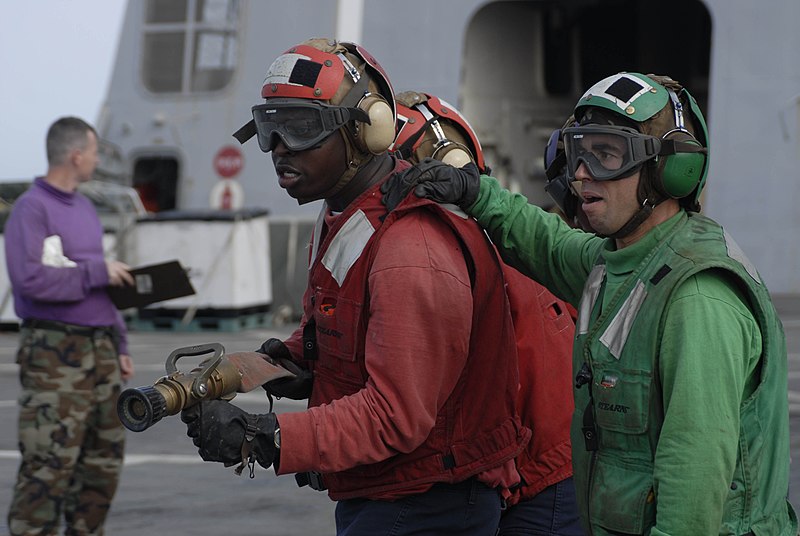 File:US Navy 100619-N-3358S-009 Hose team leader Aviation Support Equipment Technician 3rd Class Peoro Amieva, right, from Gijan, Spain.jpg