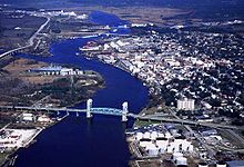 The Cape Fear Memorial Bridge (foreground) carries US 17 Business, US 76 and US 421 across the Cape Fear River WilmingtonAerialViewCoastGuard.jpg
