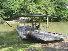 A hand-cranked ferry takes visitors across the river to the Maya site of Xunantunich.