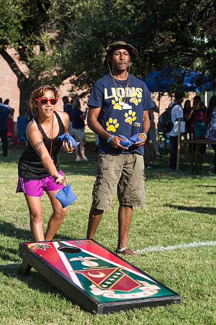 Tailgaters often pass the time with lawn games like cornhole