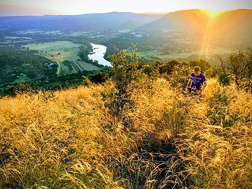 The view from the top of Aasvoelkop in the heart of the Vredefort impact structure with the Vaal River and Venterskroon on its right in the background Aasvoelkop.jpg