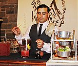 A bartender making a classic cocktail, 2010s