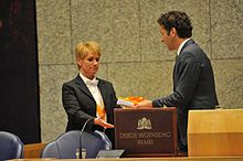 Accountability Day 2013 - Minister Dijsselbloem offers the 2012 Accountability files to a House aide. Dijsselbloem verantwoordingsdag 2013.jpg