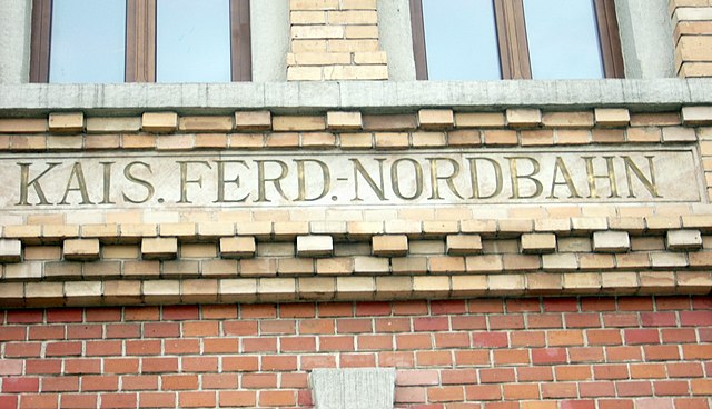 Kaiser Ferdinands-Nordbahn inscribed in abbreviated form on the façade of the main railway station in Bielsko-Biała, Poland