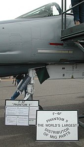 An F-4F on display described as the World's largest distributor of MiG parts, because of the high number of this type of enemy aircraft shot down