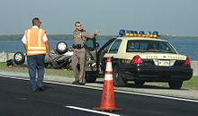 A Florida Highway Patrol trooper and a government worker at the scene of a traffic collision Florida Highway Patrol in action.jpg