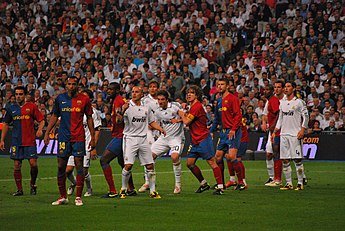 Players jostle in Barcelona's 2-6 win against Real Madrid at the Santiago Bernabeu Stadium in a 2009 El Clasico Forcejeo Real Madrid - FC Barcelona.jpg