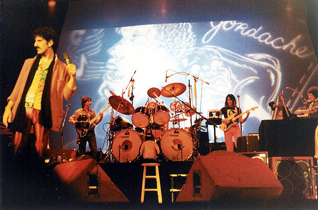 Steve Vai (on guitar in between the drums and keyboard, to the right), Frank Zappa and band during a concert at the Memorial Auditorium in Buffalo, Ne