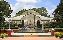 The Lal Bagh, famous for its flower shows was commissioned in 1760. Glasshouse and fountain at lalbagh.jpg