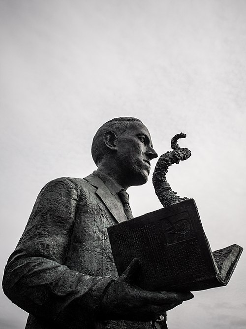 Statue of H. P. Lovecraft, the author who created the Necronomicon as a fictional grimoire and featured it in many of his stories