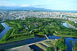 Bird eye view on a star shaped fortress with surrounding water filled moat.