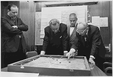 Lyndon Johnson and aides examining a model of Khe Sanh during the Vietnam War Lyndon Johnson KheSanh Sandbox.gif