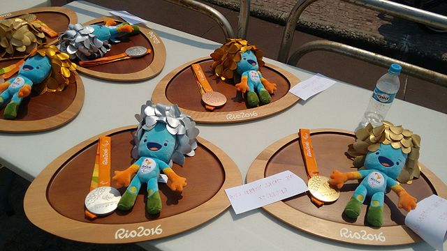 Paralympic medals and the mascot Tom.