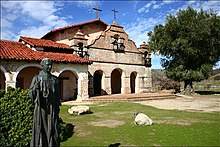 The reconstructed Mission San Antonio de Padua as it appeared in 2006. The baked brick Campanario is unique among the Missions. Mission San Antonio de Padua modern.jpg