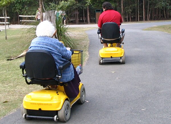 Two people using mobility scooters