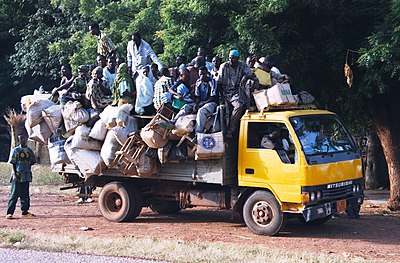 A truck, like many seen on West Africa roads, picks up travelers along a road in southwest Niger. Niger highway overloaded camion 2007.jpg