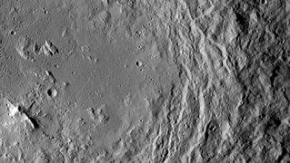 Mountain (lower left) in the center of Urvara crater