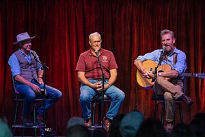 Feek on stage with Gabe Mccauley and Joel Salatin at the Music Ranch Montana on July 10, 2021