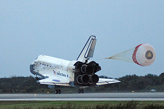 Space Shuttle Discovery on landing, showing its rudder deployed in speed brake mode STS-116 landing port behind.jpg