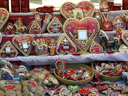 Decorated gingerbread hearts with mirrors, hussars, and market souvenirs in Croatia