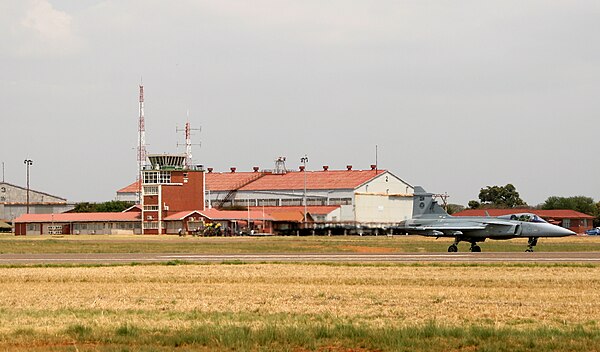 Control tower at AFB Waterkloof with a South African Air Force Saab JAS 39 Gripen in the foreground.