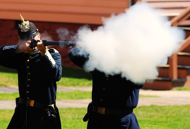 Reenactment firing a Springfield Model 1873 breech-loading rifle at Fort Mackinac in 2008