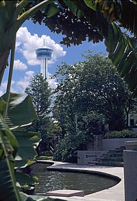 The River Walk with the Tower of the Americas in the background Tower of the Americas from the River Walk -- San Antonio.jpg