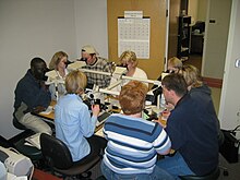 An anatomical pathology instructor uses a microscope with multiple eyepieces to instruct students in diagnostic microscopy. UNDmicroscope.jpg