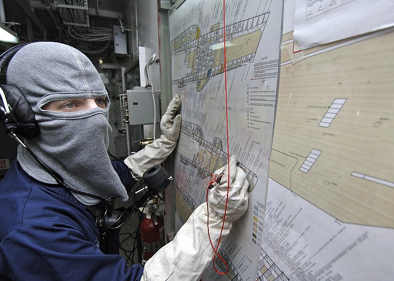 File:US Navy 060311-N-1045B-018 Aviation Electronics Technician 2nd Class Timothy Davis manually plots simulated shipboard casualties on a damage control plotting board during a general quarters (GQ) drill.jpg