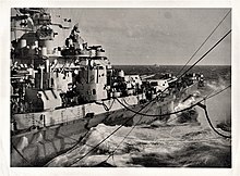 Close-in fueling between a U.S. battleship traveling at 12 knots and an oiler (out of frame on right). Battle of Okinawa, April-June 1945. View of close-in rig of USS Manattee (AO-58) while refueling US battleship at sea during Battle of Okinawa, 1945.jpg