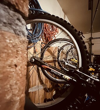 Bicycles stored on garage wall.