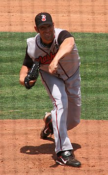 A man in a gray baseball uniform with 