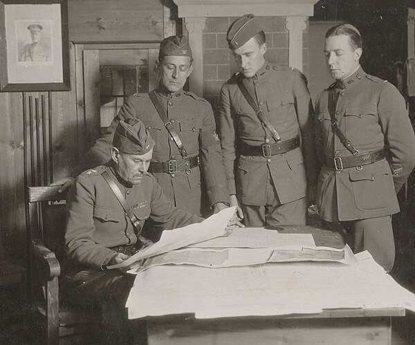 General Robert Alexander studying reconnaissance data with his aides near Varennes-en-Argonne in October 1918.