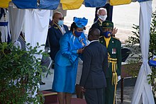The monarch's representative, the Governor-General, conferring honours during the National Awards Ceremony at the Independence Day Parade, 2020 2020 Independence Day Parade and National Awards Ceremony (50665022418).jpg