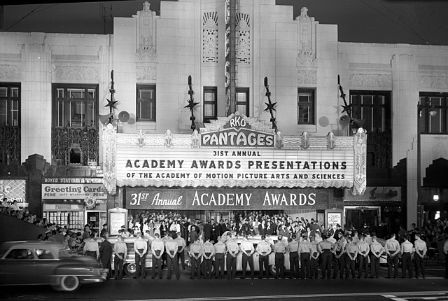 People lining the street under the marquee of the Pantages Theater at the 31st Academy Awards.