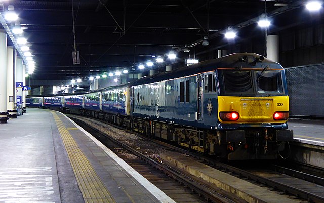 Caledonian Sleeper with 92038 in Serco midnight teal livery, at Euston, April 2015