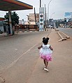 A 4 year old girl walking along Bombo road after suspension of public transport in Uganda.jpg
