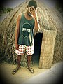 A Young Ghanaian Man Standing Beside His Farmhouse